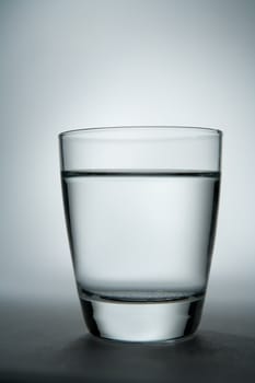 Glass of water with gradient background