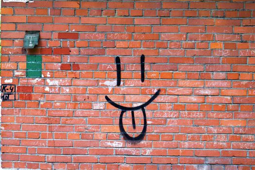 Smile Graffiti on Red Brick Wall.