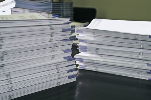 Piles of handout papers lying on table.