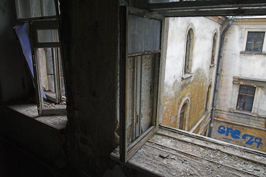View through window in abandoned house to backyard