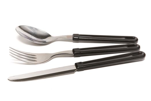 Knife, fork and spoon on a white background