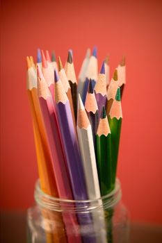 Colored pencils in a glass jar