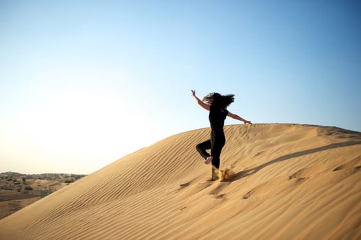 Woman enjoying the desert in Dubai, United Arab Emirates