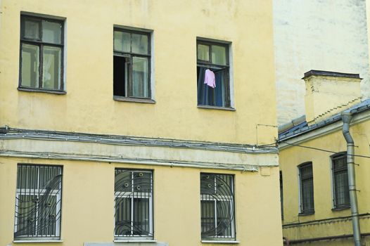 Dress hanging to dry in open window of old building