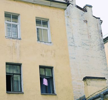 Dress hanging to dry in open window of old building