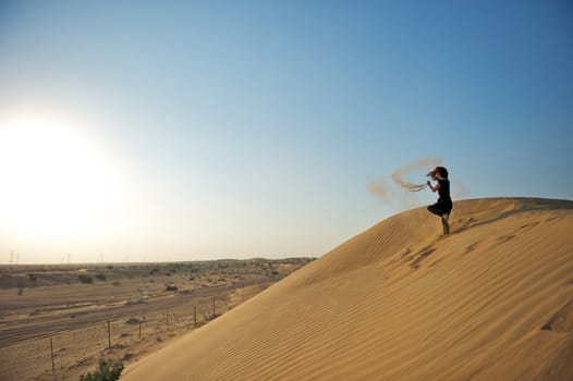 Woman enjoying the desert in Dubai, United Arab Emirates