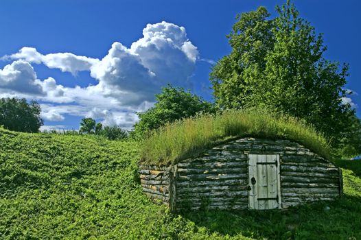 Ancient earth house near medieval Russian fortress
