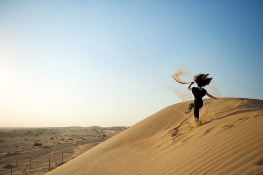 Woman enjoying the desert in Dubai, United Arab Emirates