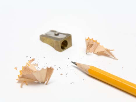 Pencil, sharpener and shavings on a white background