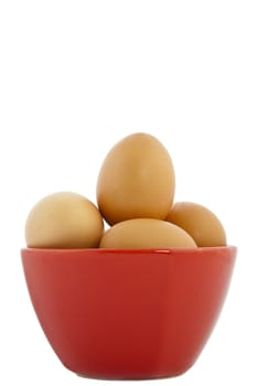 brown eggs in red bowl on white background