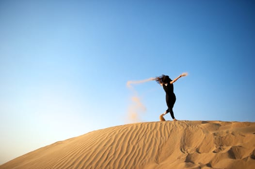 Woman enjoying the desert in Dubai, United Arab Emirates