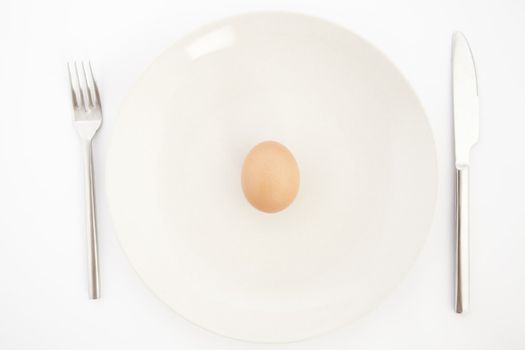 top view of one egg on white plate