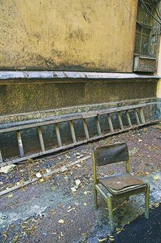 Old chair and ladder in back yard