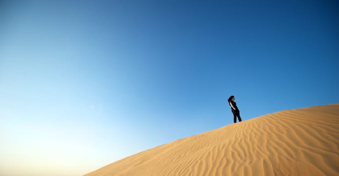 Woman enjoying the desert in Dubai, United Arab Emirates