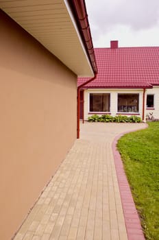 The new architecture of houses with large windows covered with a red tile roof and Drain pipes.