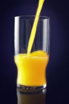 Pouring orange juice to a glass