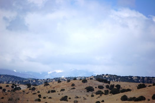 Rolling mountain hills with clouds