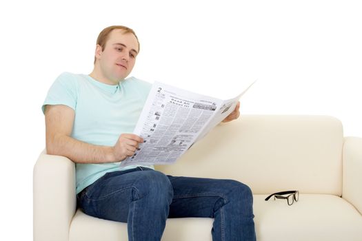 A man reads the newspaper at home