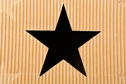 Star shaped hole in cardboard box