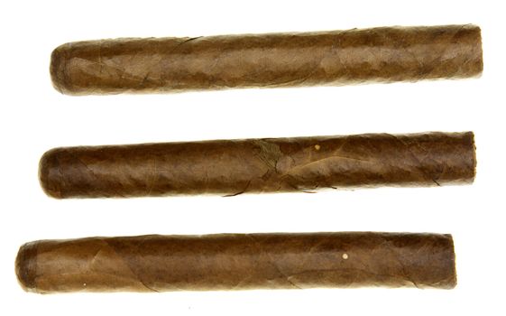 Three authentic Cuban cigars isolated on white.
