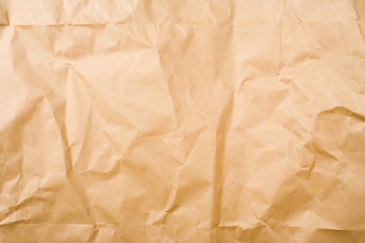 Crumpled brown packaging paper sheet texture background