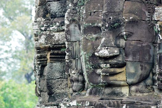 Giant ancient buddha rock statue at Angkor Cambodia