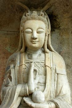 Ancient stone sculpture of a smile buddha in China