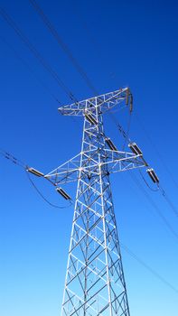 High voltage transmission lines with blue sky as background