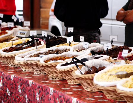 Fresh and dry fruit placed onto a table, outdoors