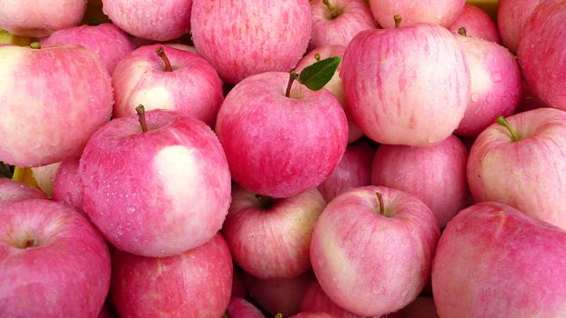 Piles of fresh red apples in a market