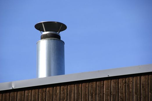 Pipe of ventilation are located on a roof of a  building