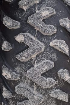 the clue of white sand on a tire wheel 