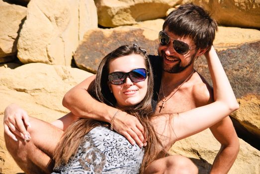 Young happy couple on the rocks. Shoot on the nature.