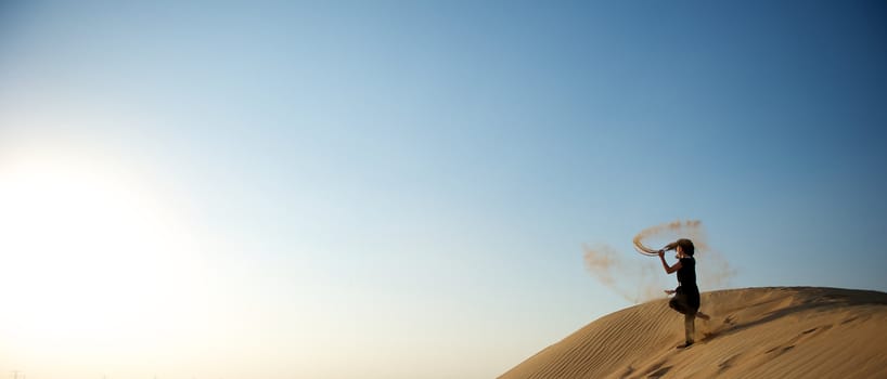 Woman enjoying the desert in Dubai, United Arab Emirates