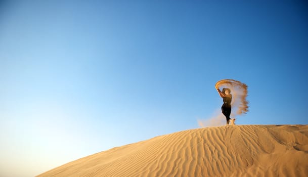 Woman enjoying the desert in Dubai, United Arab Emirates