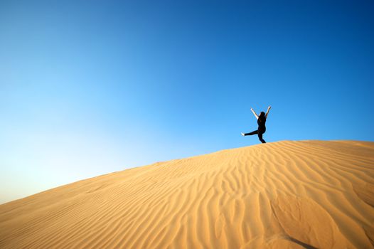 Woman enjoying the desert in Dubai, United Arab Emirates