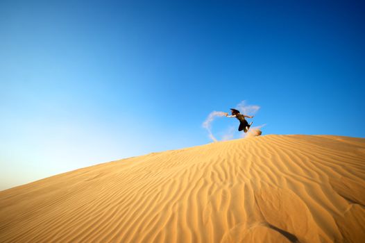 Woman enjoying the desert in Dubai, United Arab Emirates