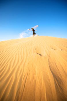 Woman enjoying the desert in Dubai, United Arab Emirates