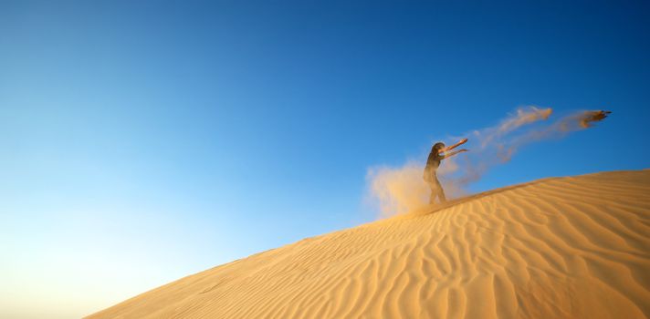 Woman enjoying the desert in Dubai, United Arab Emirates