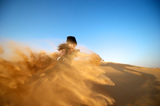 Woman enjoying the desert in Dubai, United Arab Emirates