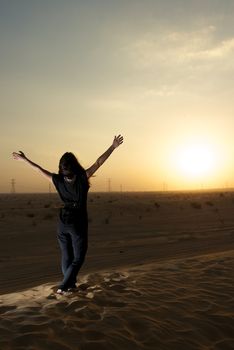 Woman enjoying the desert in Dubai, United Arab Emirates