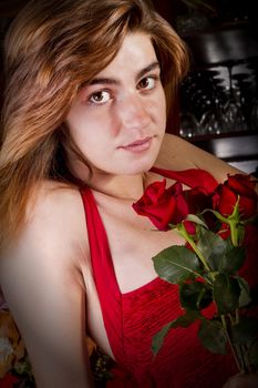 View of a beautiful young girl in a red dress on a living room.