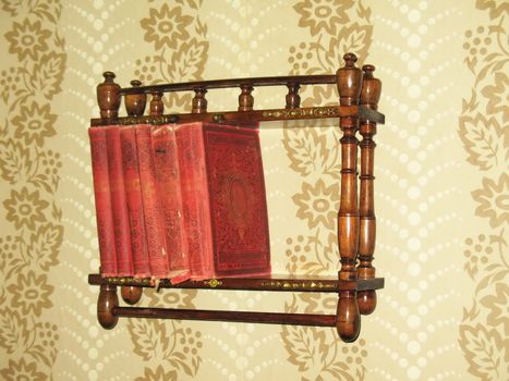 books on wooden bookshelf on white wall