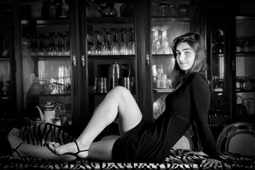 View of a beautiful young girl in a black dress on a living room.
