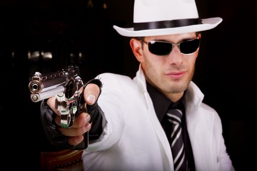 View of a white suit gangster man holding a gun.