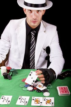 View of a gangster man playing some cards and poker.