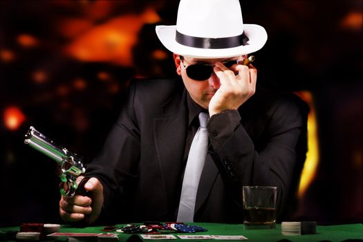 View of a gangster man playing some cards and poker.