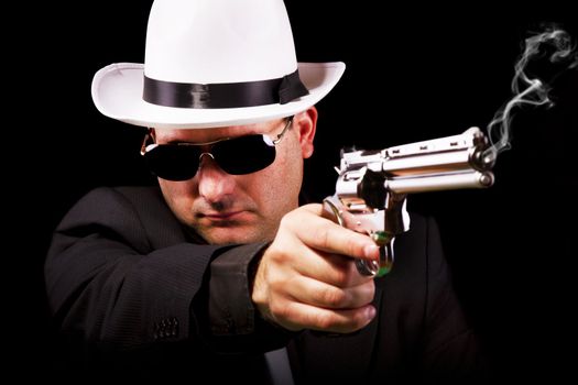 View of a white suit gangster man holding a gun.
