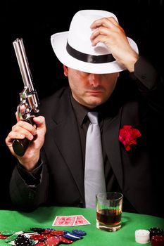 View of a dark suit gangster man holding a gun.