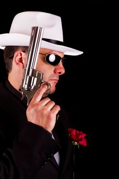 View of a dark suit gangster man holding a gun.